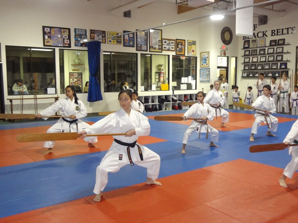 students doing traditional weapons in class